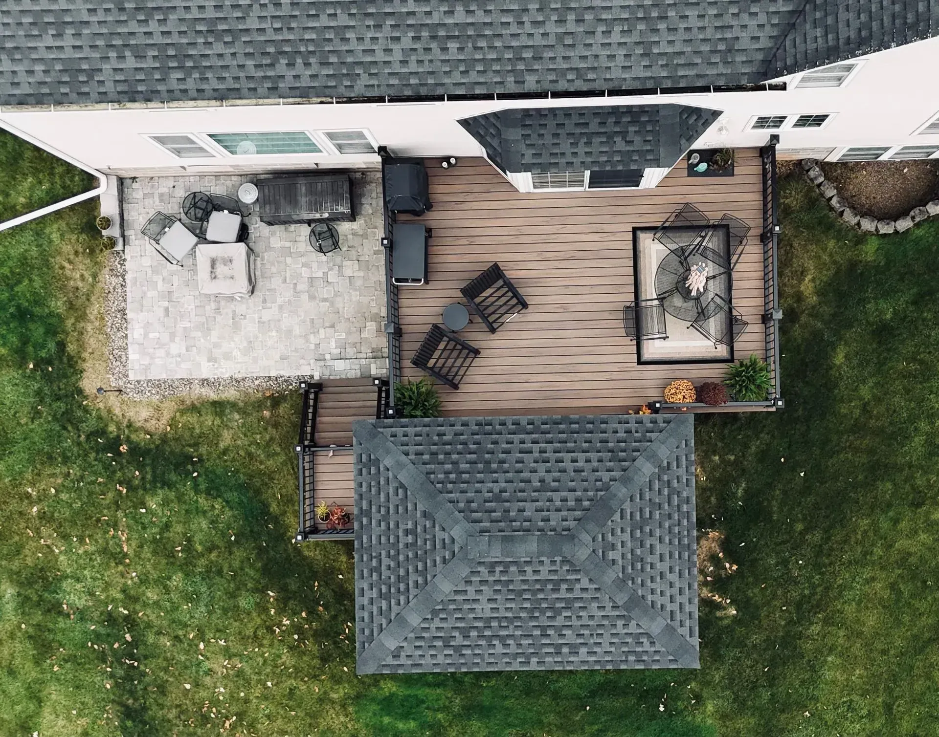 An aerial view of a house with a large deck and patio.