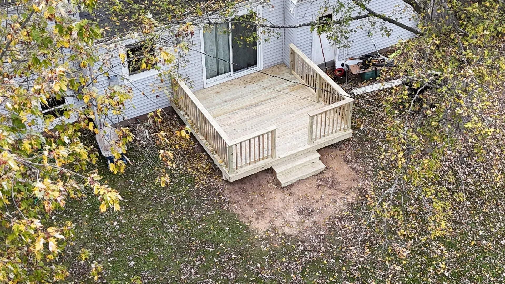 An aerial view of a wooden deck in front of a house.