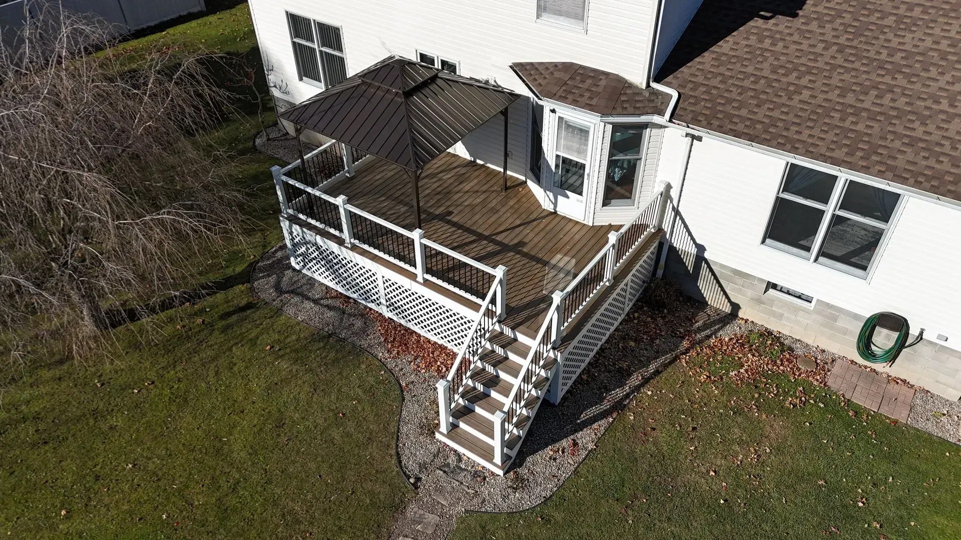 An aerial view of a house with a deck and stairs.