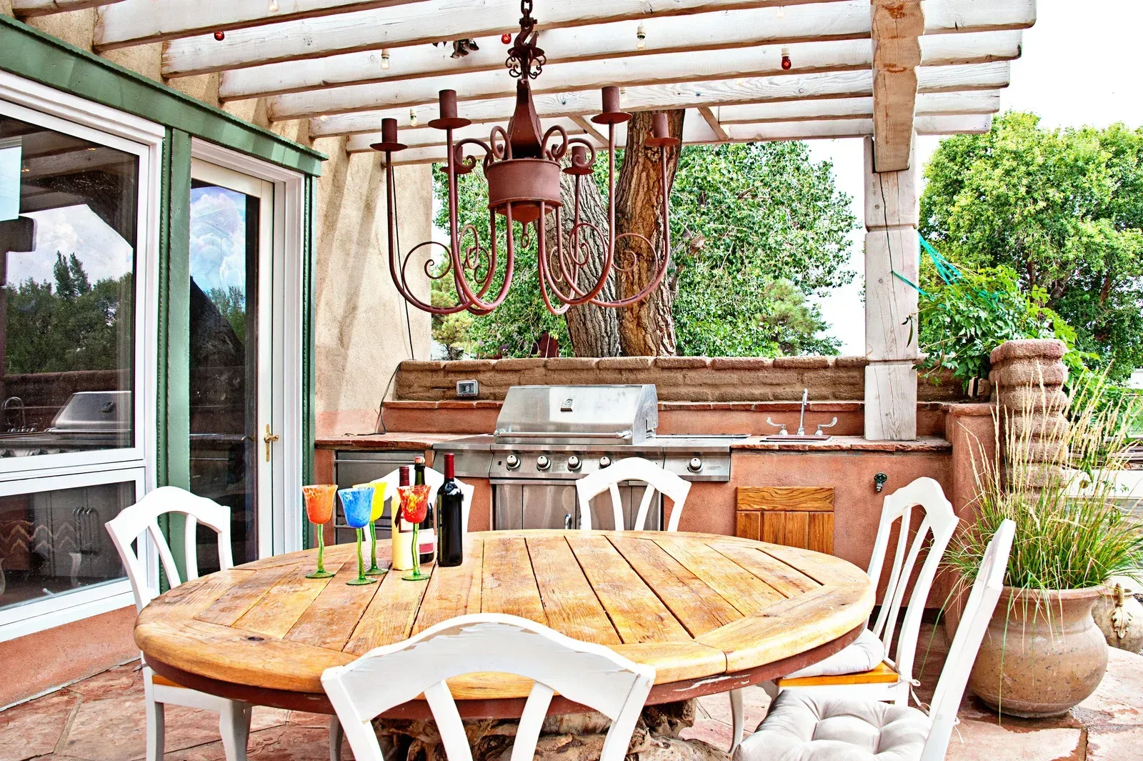 A patio with a table and chairs under a pergola