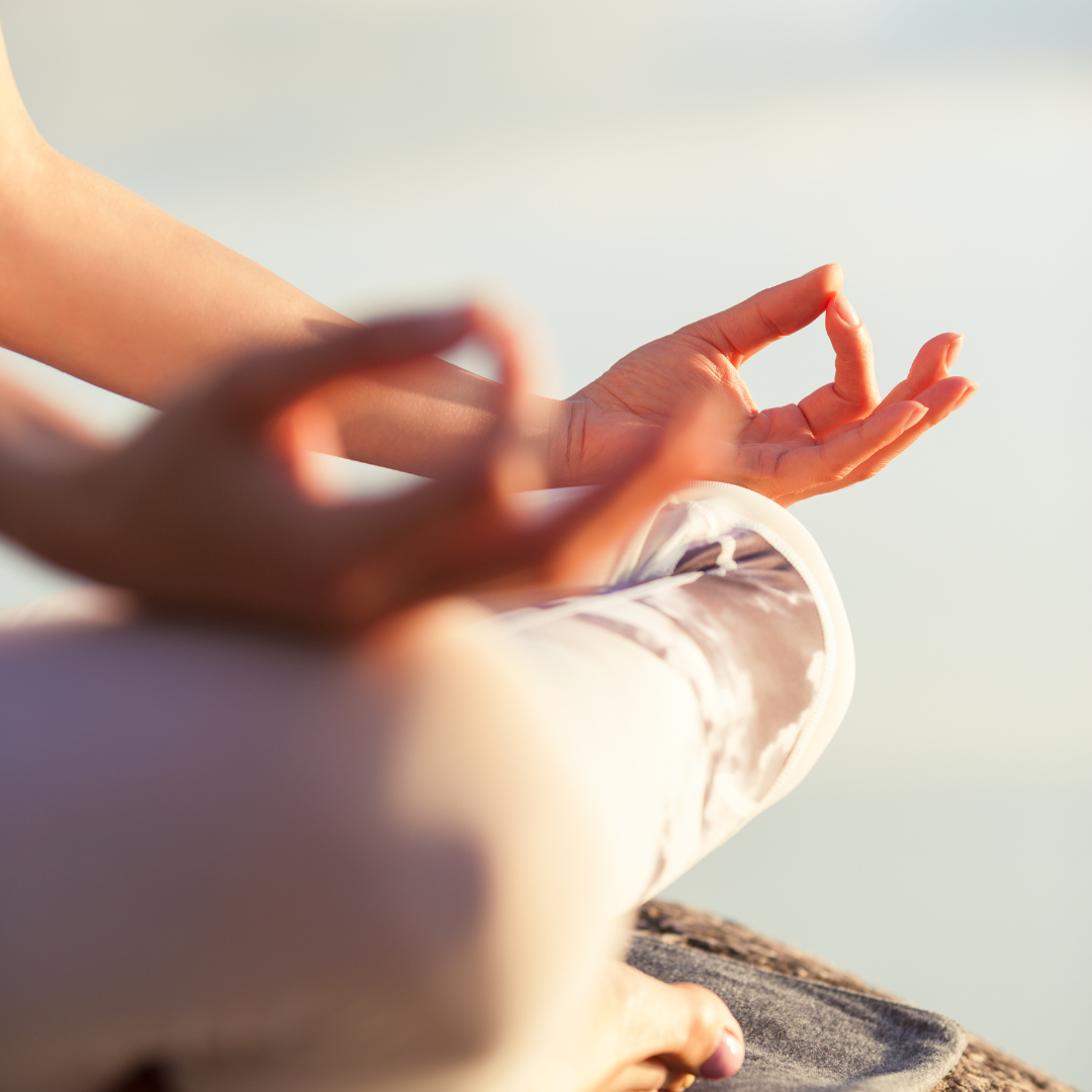 Hands resting on crossed legs gesturing meditation — Counselling in Croudace Bay,NSW