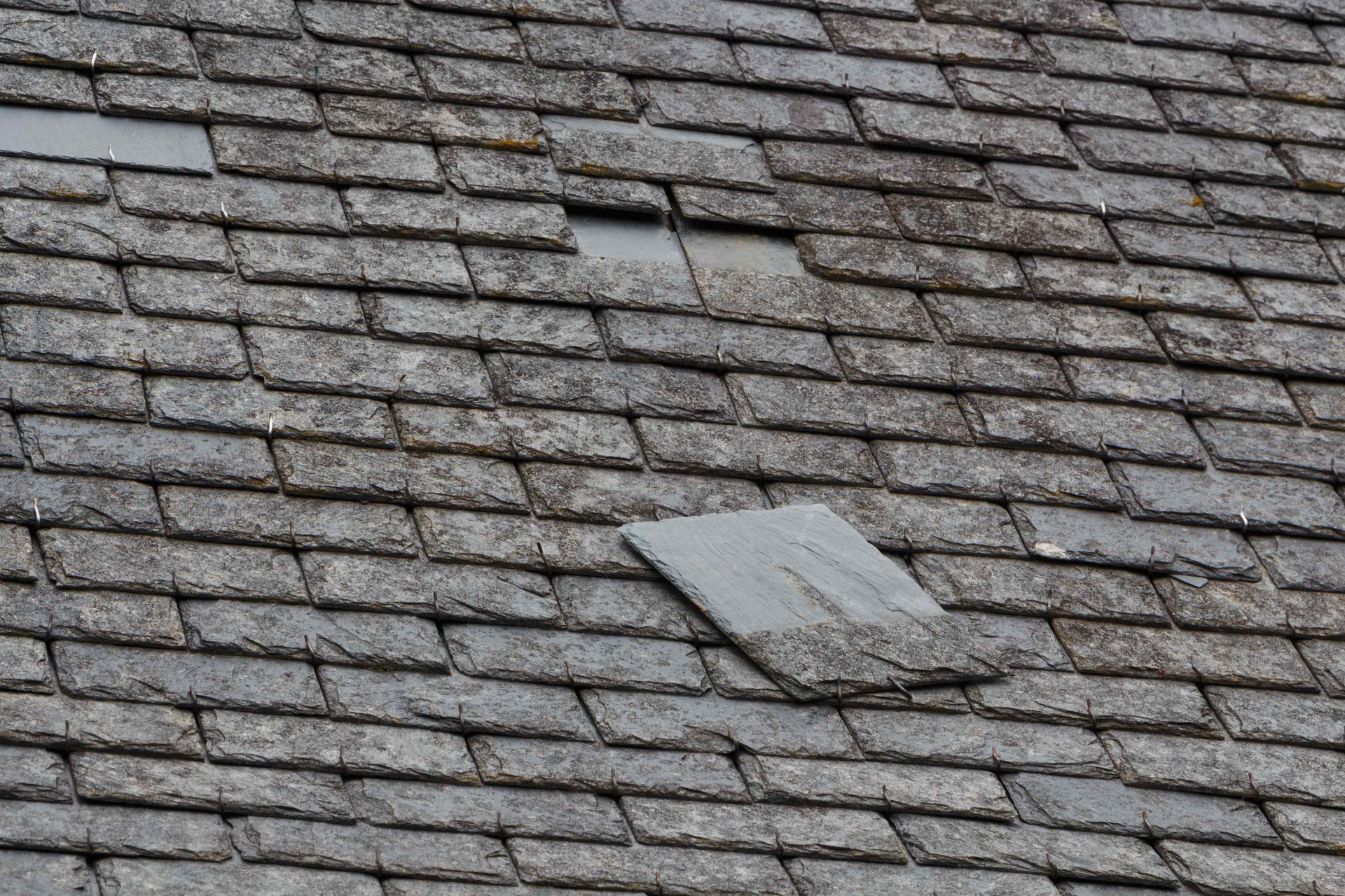 slate roof with missing slate tiles 