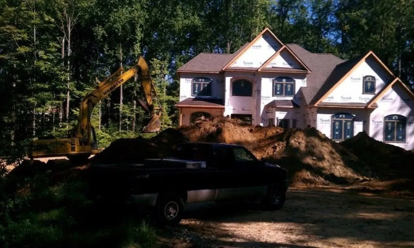A truck is parked in front of a house under construction
