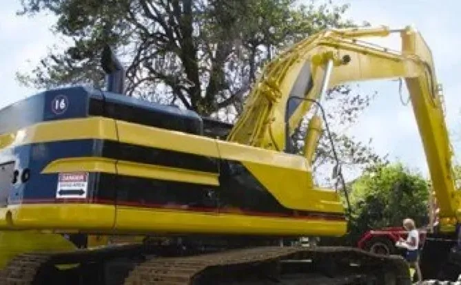 A yellow excavator with the number 14 on it