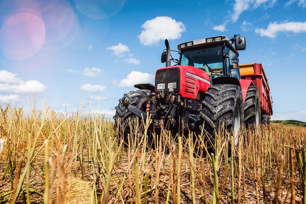 A Red Tractor is Driving Through a Field of Tall Grass — LJE MechanicaI  Narromine, NSW