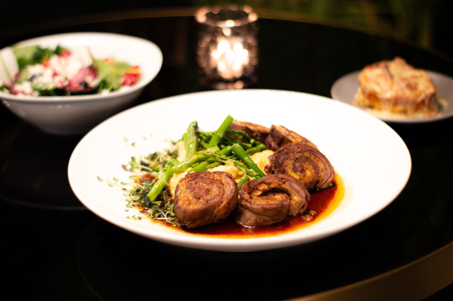A plate of food with meat and vegetables on a table.