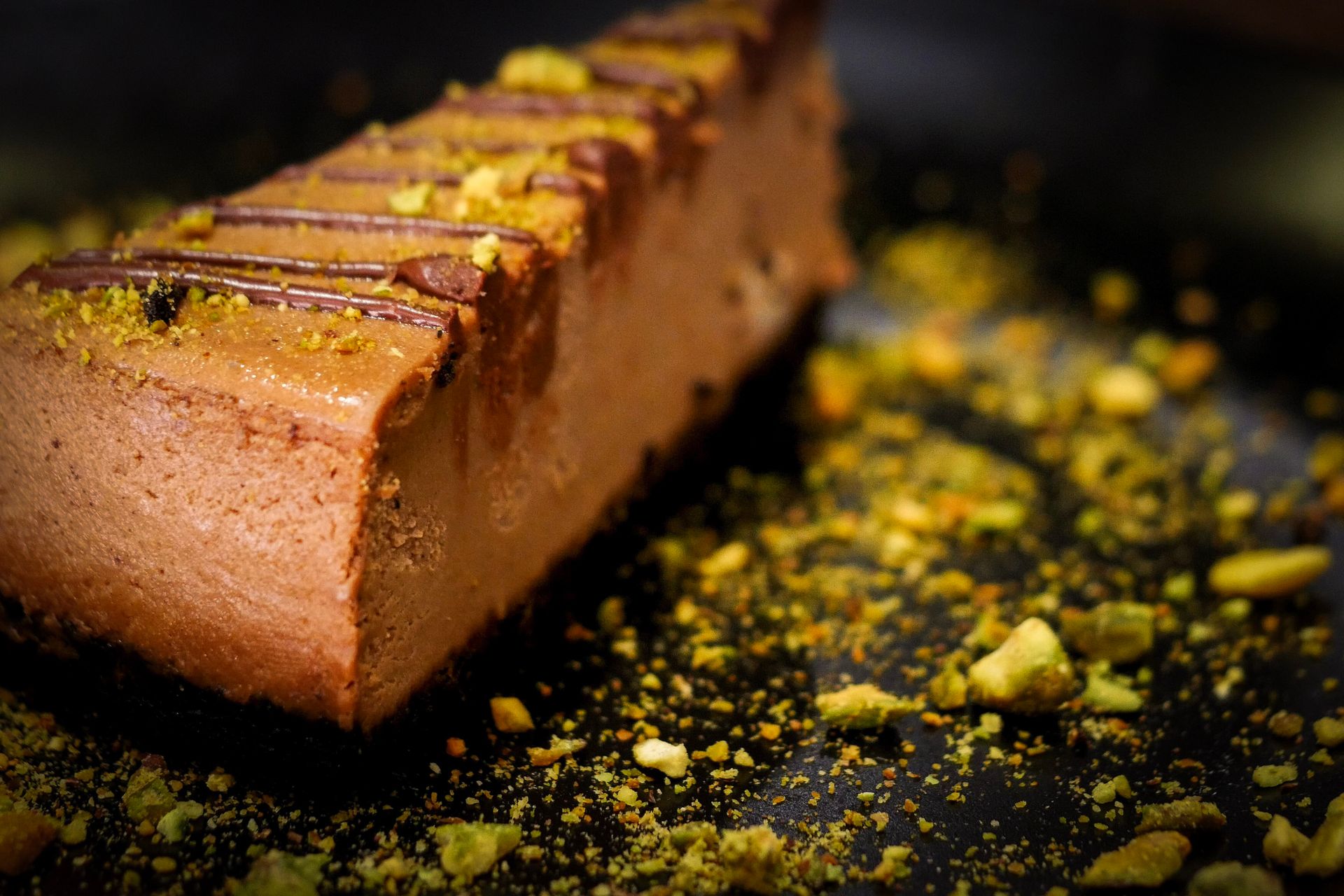 A close up of a piece of chocolate cake on a table.