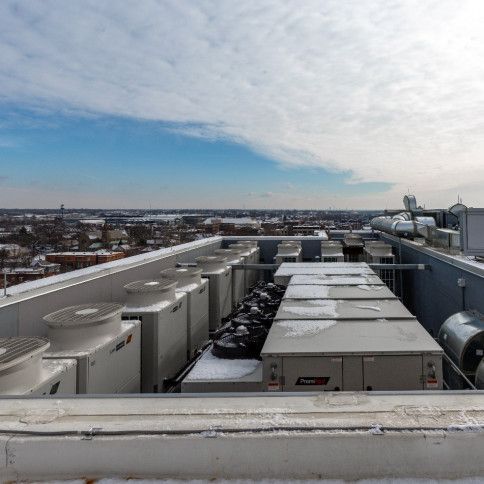 The roof of a building with a lot of air conditioners on it.