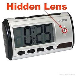 A digital alarm clock with a hidden camera on it.