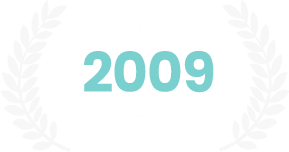 Light blue “2009” centered on a white background with faint gray laurel wreaths