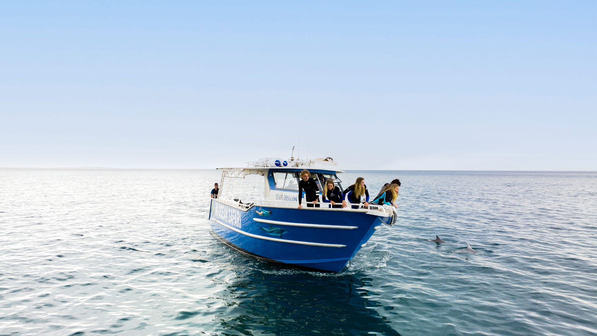 Breakfast spread: toast, fruit bowls, coffee, smoothies on a wooden table