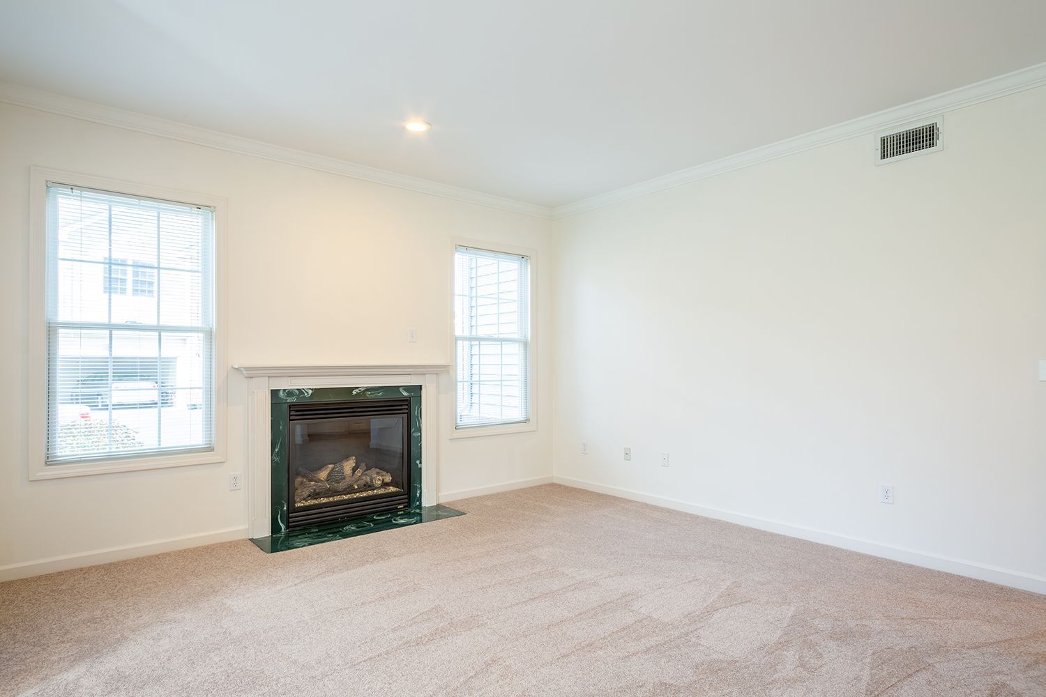 Living room photo showing fireplace with windows on either side