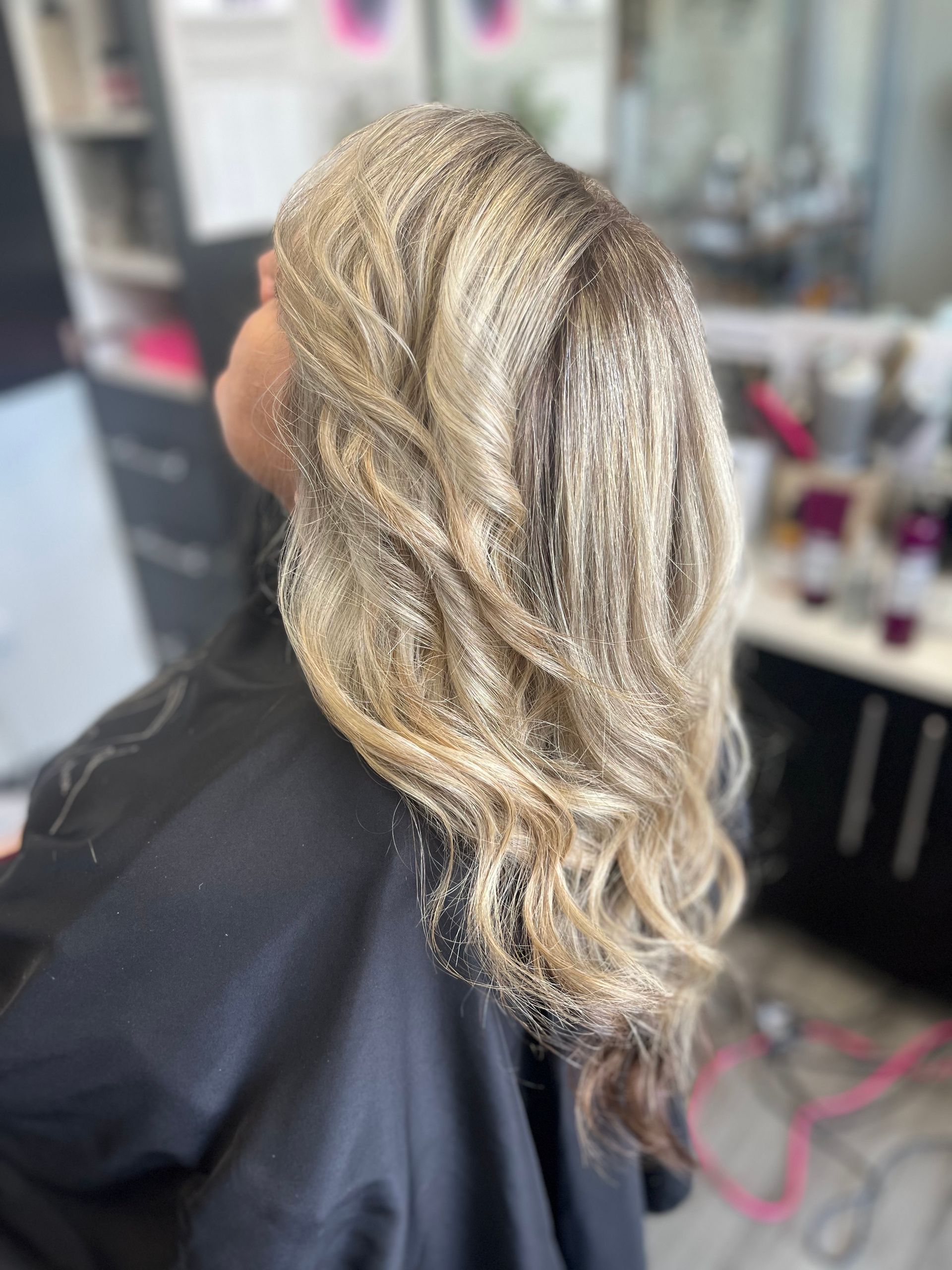 A woman is getting her hair done in a salon.
