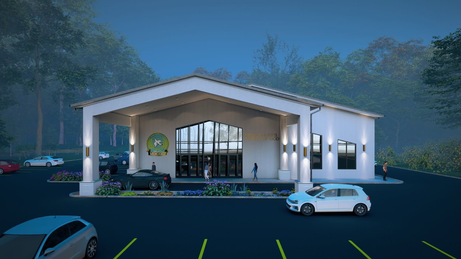 White building with a covered entrance, large glass doors, and parked cars, set in a wooded area at dusk.