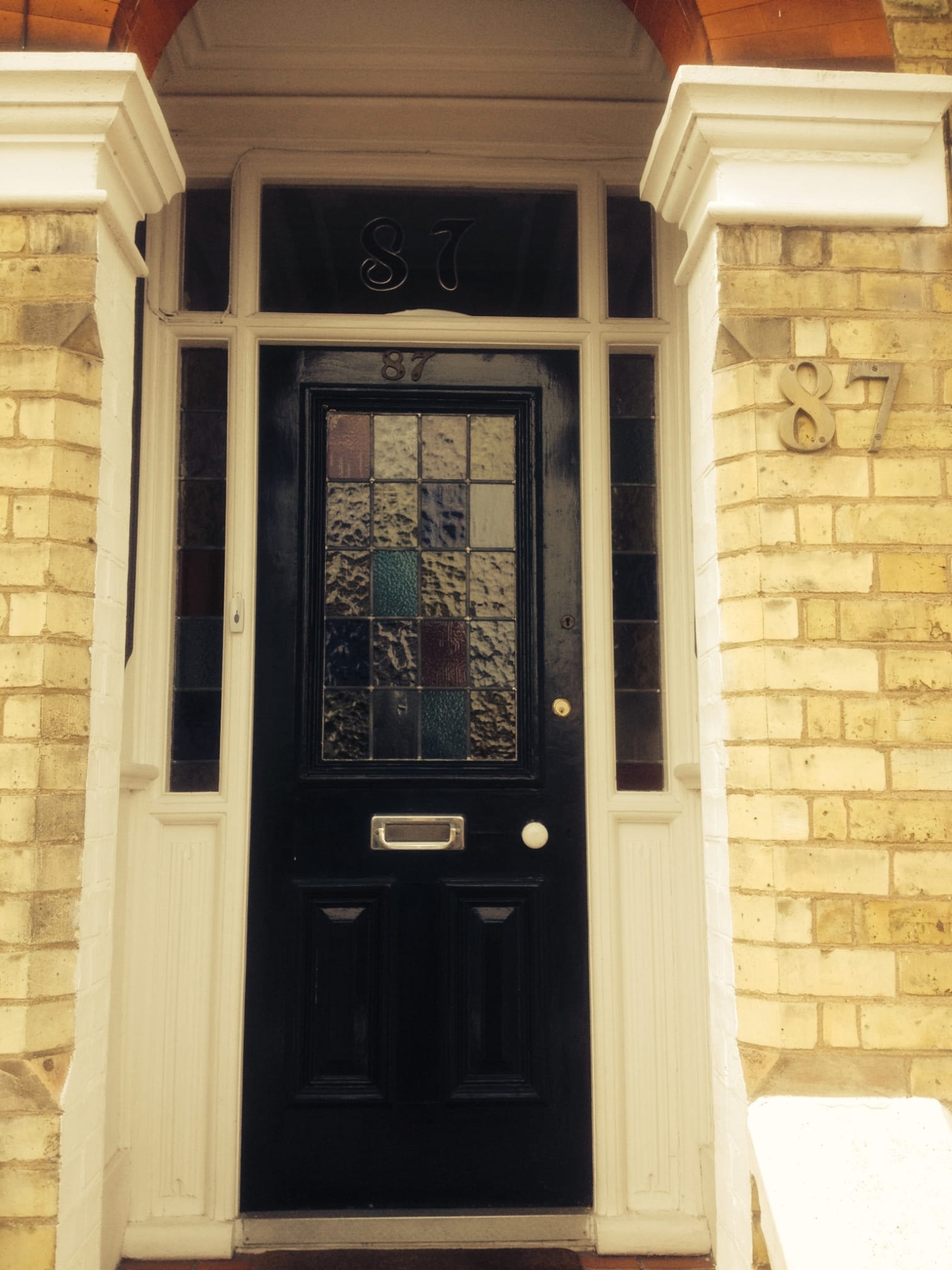 black door with dark stained glass window