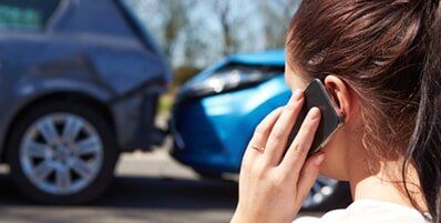 A woman calling her vehicle accident lawyer in Centennial, CO