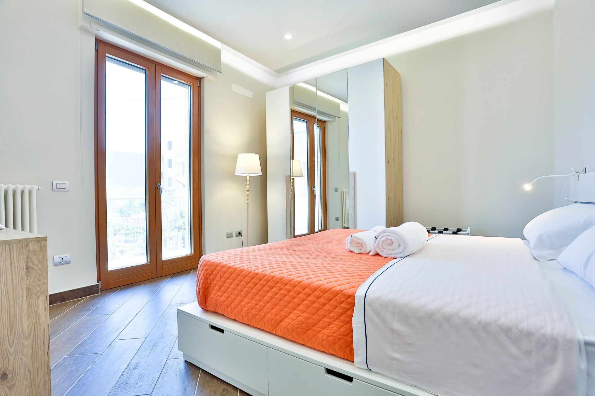 Bedroom with a king-size bed and a large window.