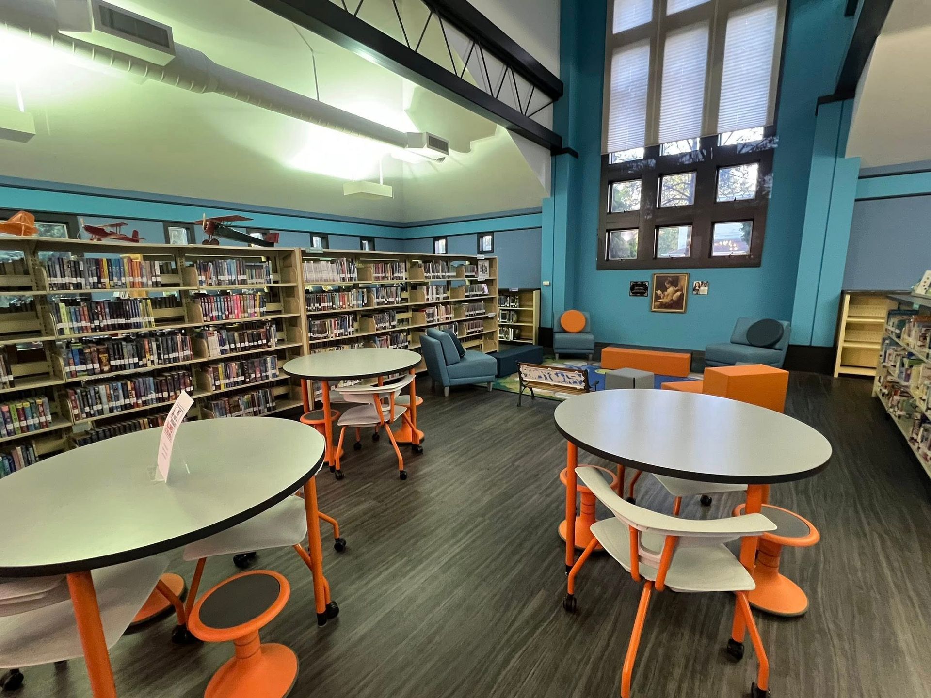 A library filled with books and tables and chairs
