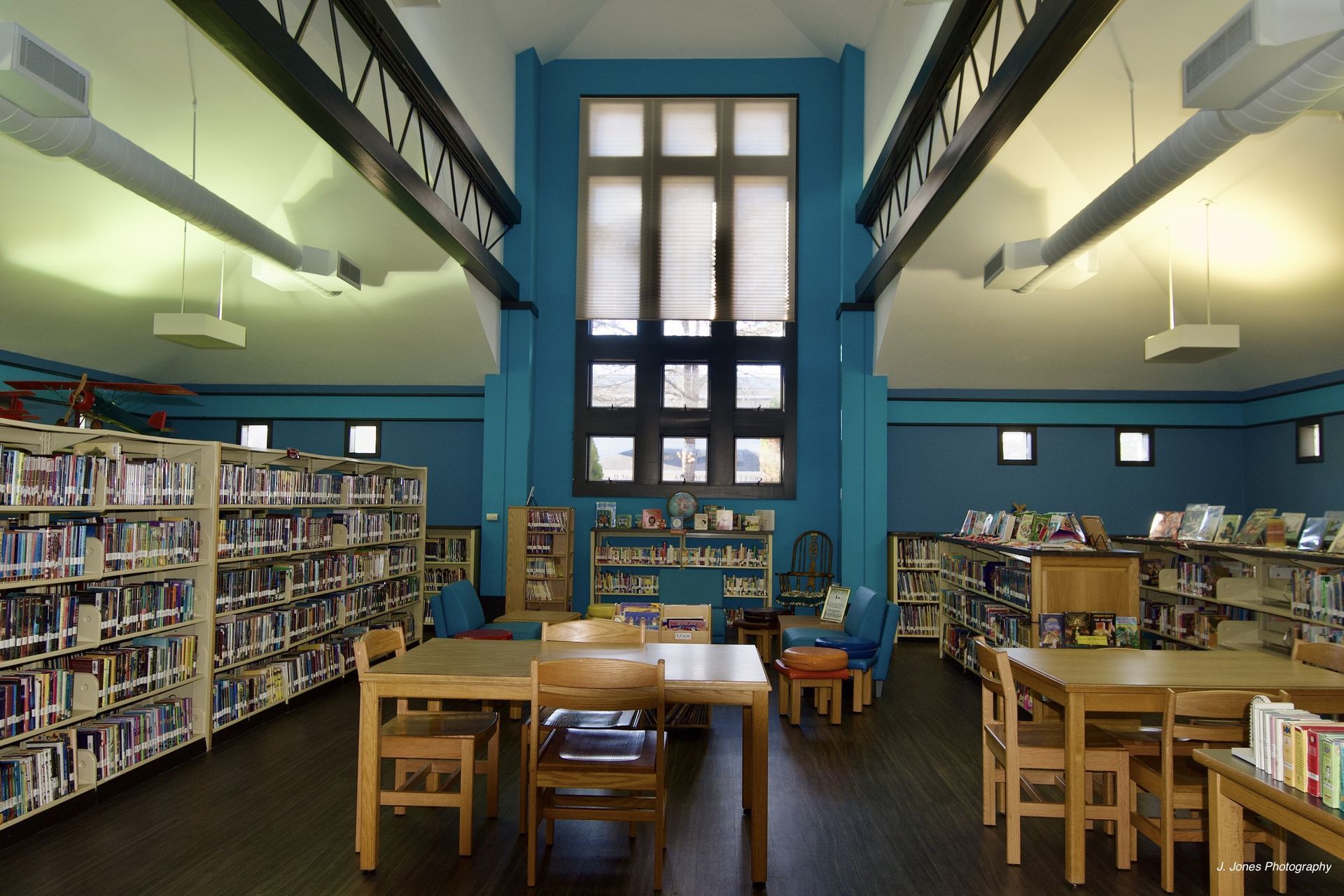 A library filled with books and tables and chairs