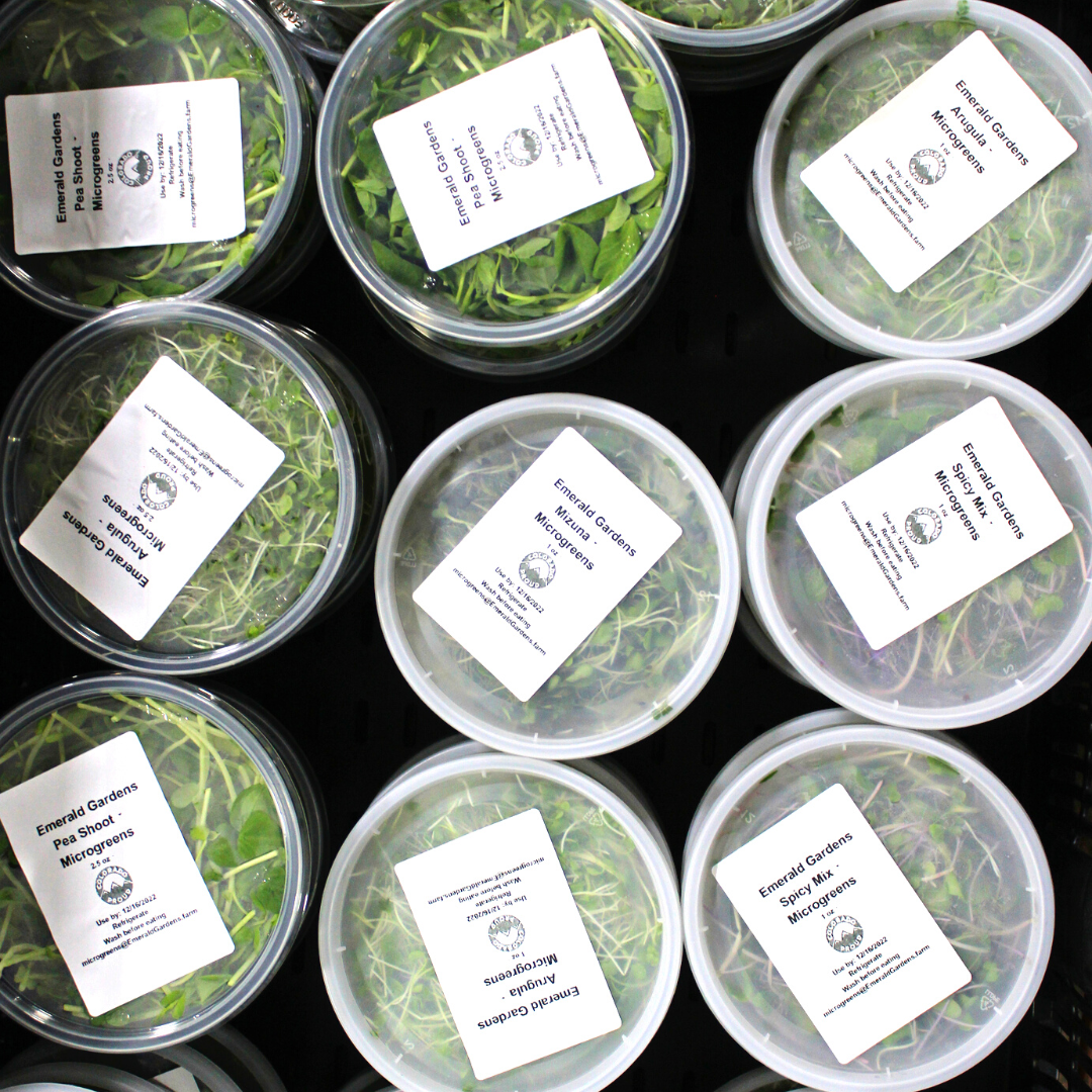Nine clear containers filled with herbs, each with a white label on top.