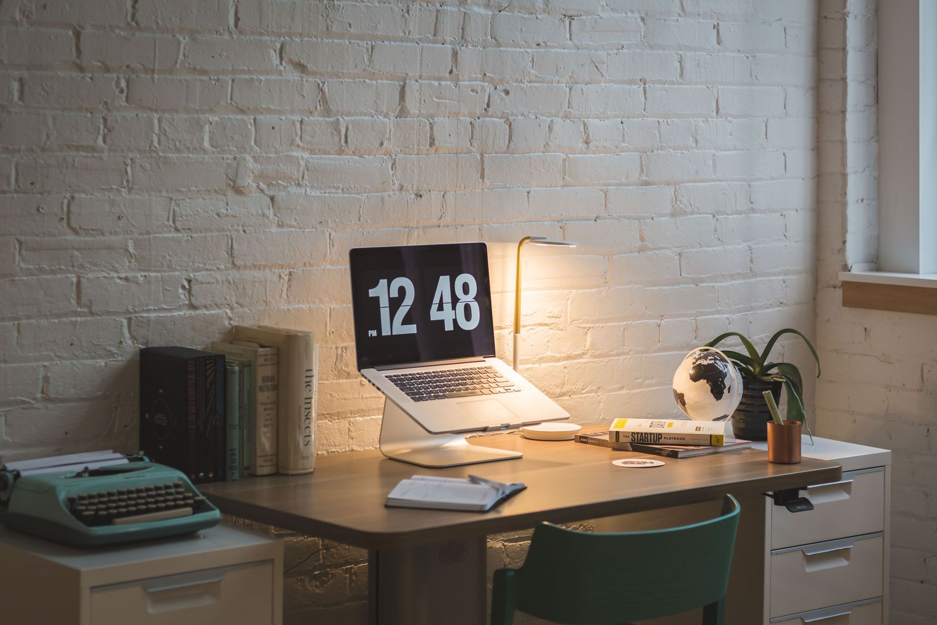 Modern home office remodel with custom workspace, brick accent wall, and built-in desk in Ogden, Utah