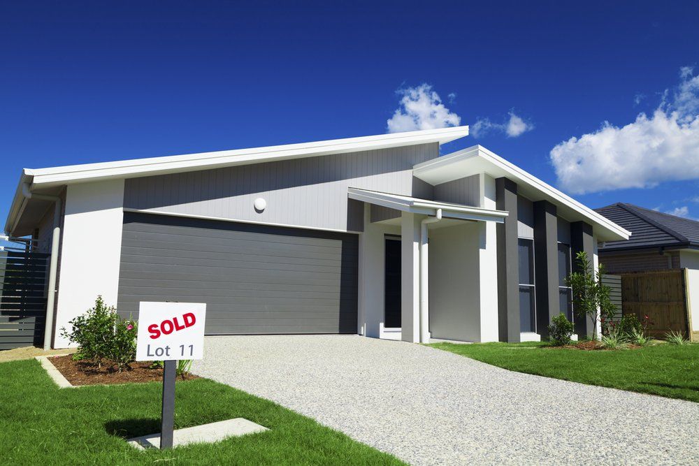 Australian House With Small Sold Sign — Builders in Byron Bay, NSW