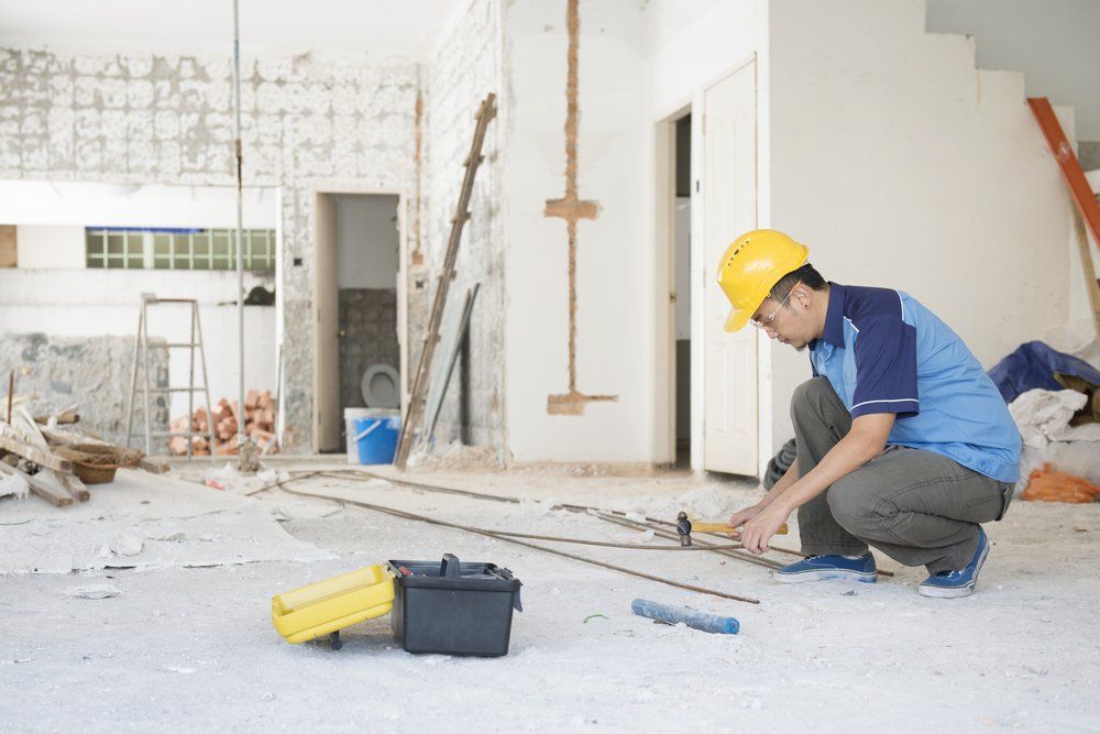 Construction Worker With Hardhat Working at Site — Builders in Byron Bay, NSW