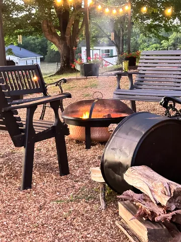 There is a fire pit in the middle of the yard.