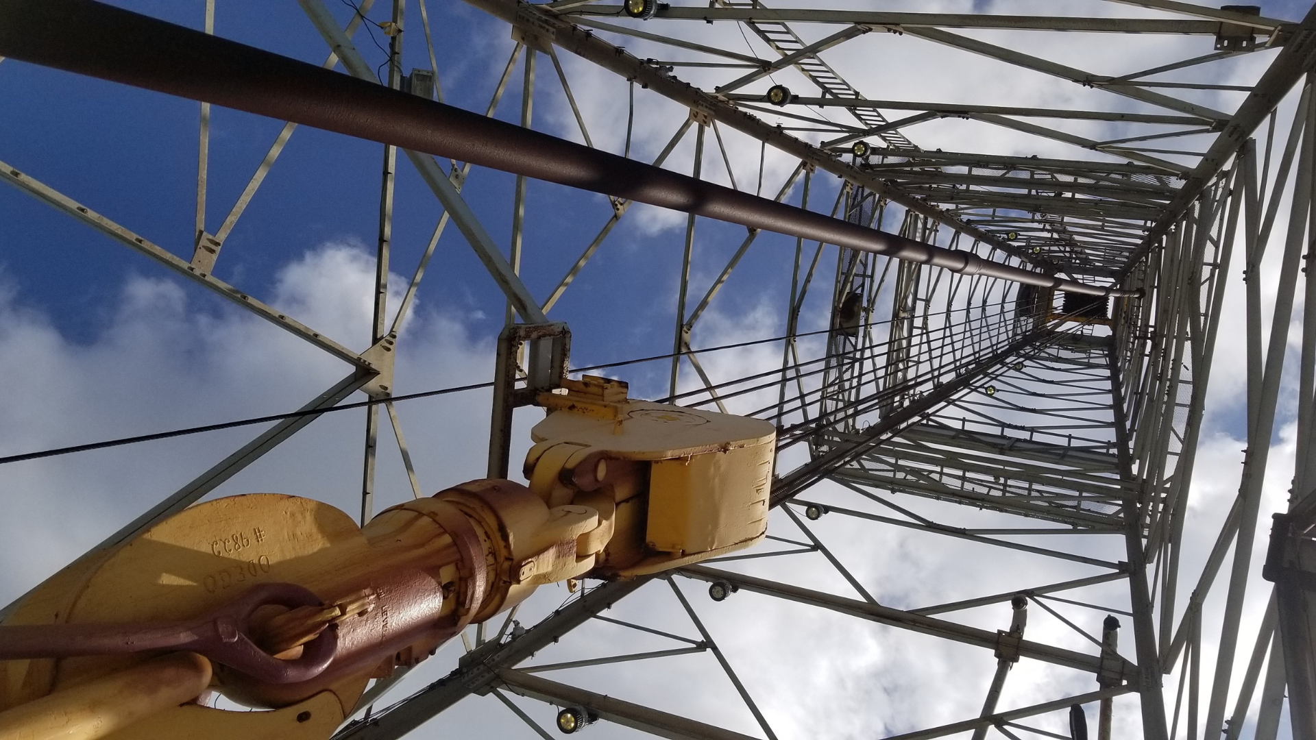 Looking up at a metal structure with a blue sky in the background