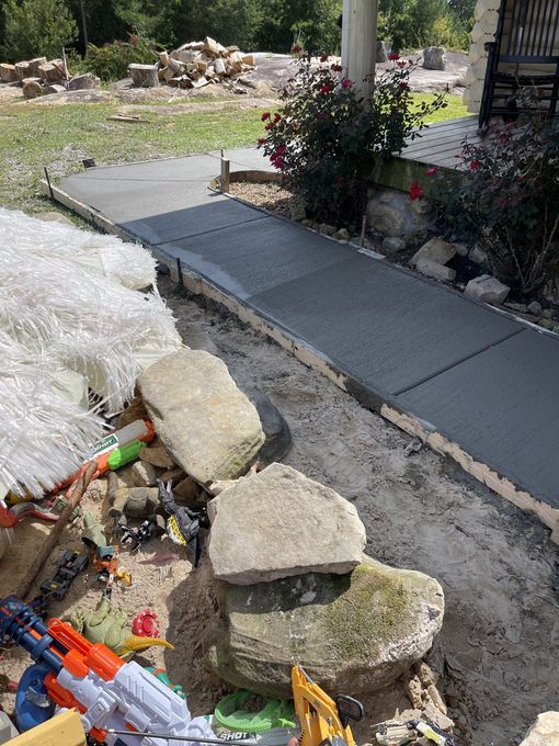 A sidewalk with a lot of rocks and toys on it.