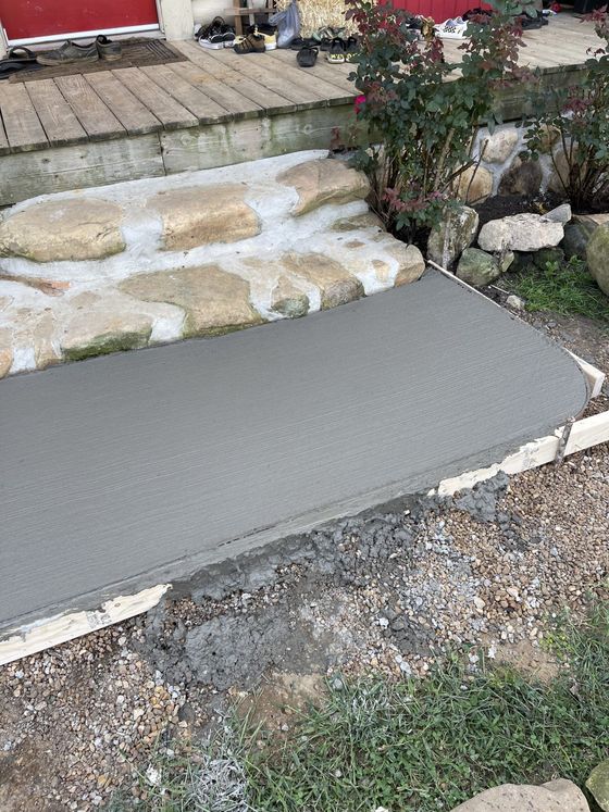 A concrete walkway is being built next to a set of stairs.