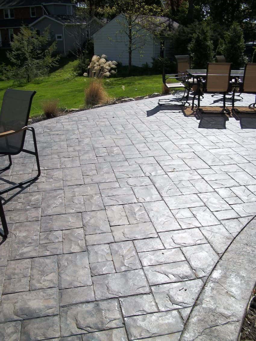 A patio with a table and chairs on it.