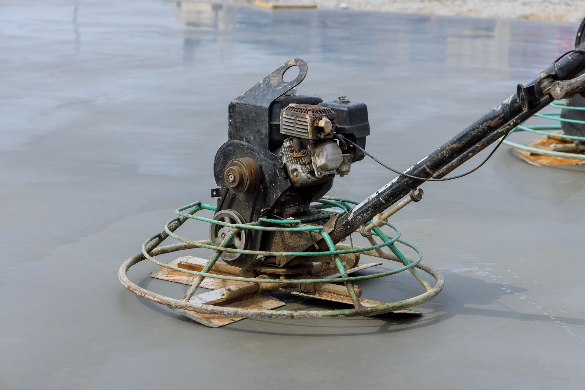 A concrete finisher is being used to finish a concrete floor.