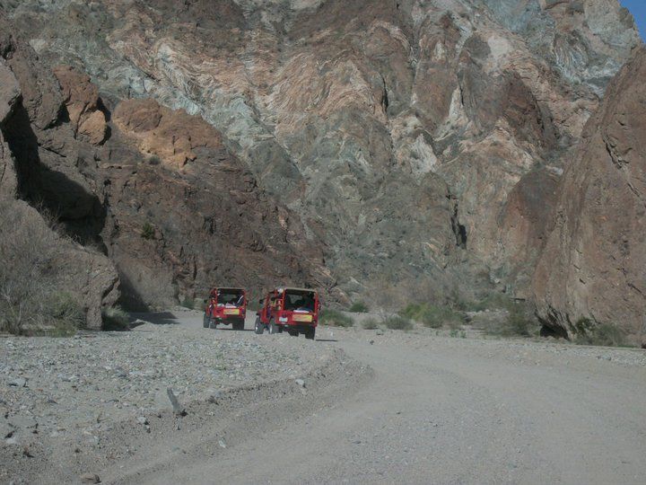 2 Red Jeeps driving on a trail into the Painted Canyon