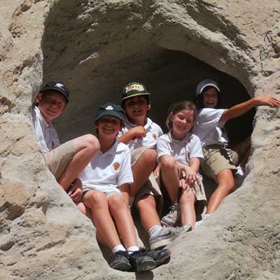 Five smiling kids wearing white shirt