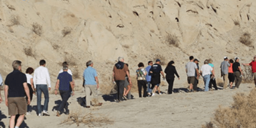 A line of people taking a tour for the Geology Hike with Red Jeep Tours