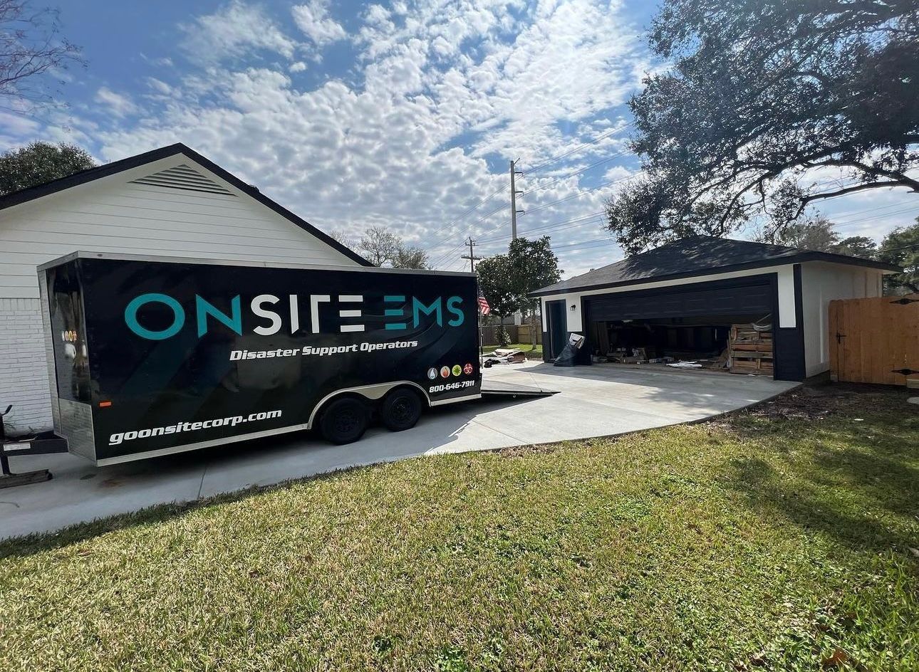 A trailer is parked in front of a house.