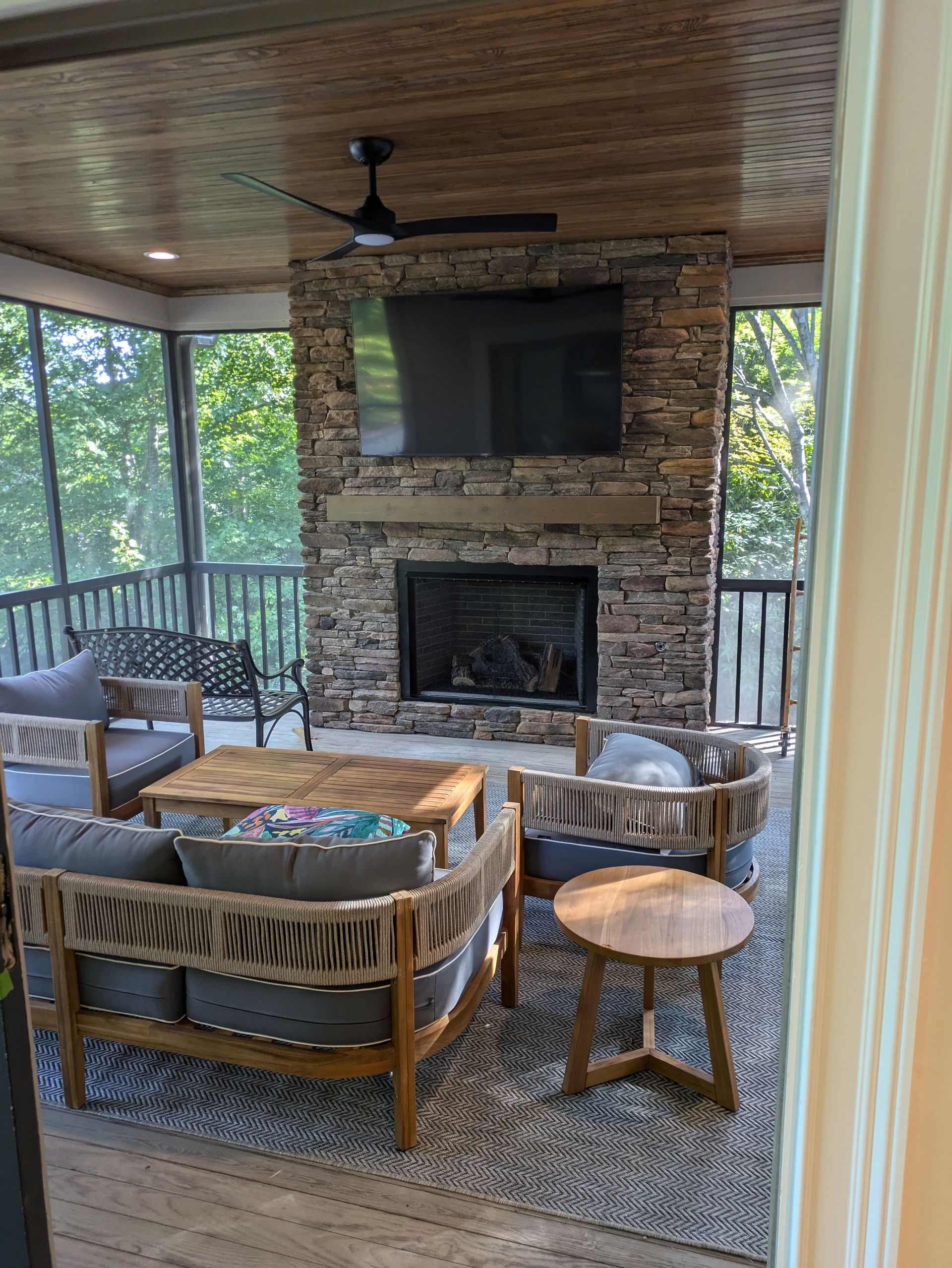 A living room with a fireplace and a flat screen tv.