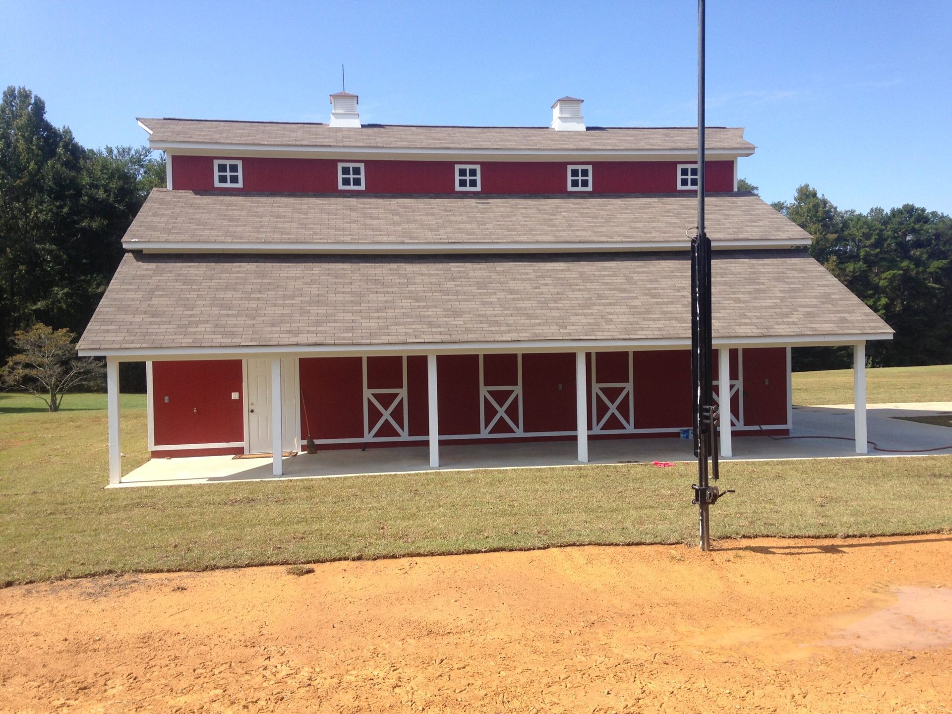 A red barn with a basketball hoop in front of it