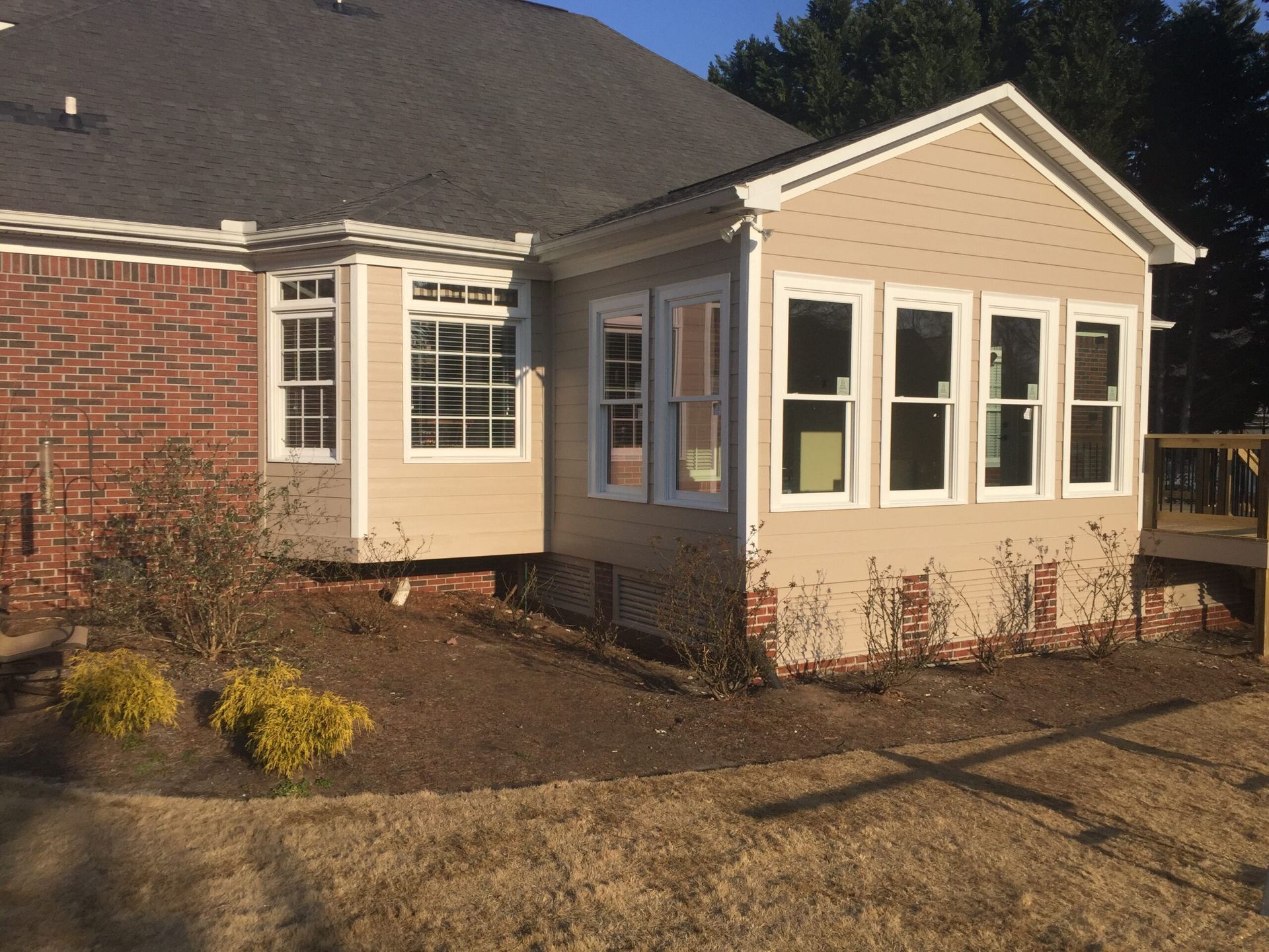 A house with a sunroom attached to it