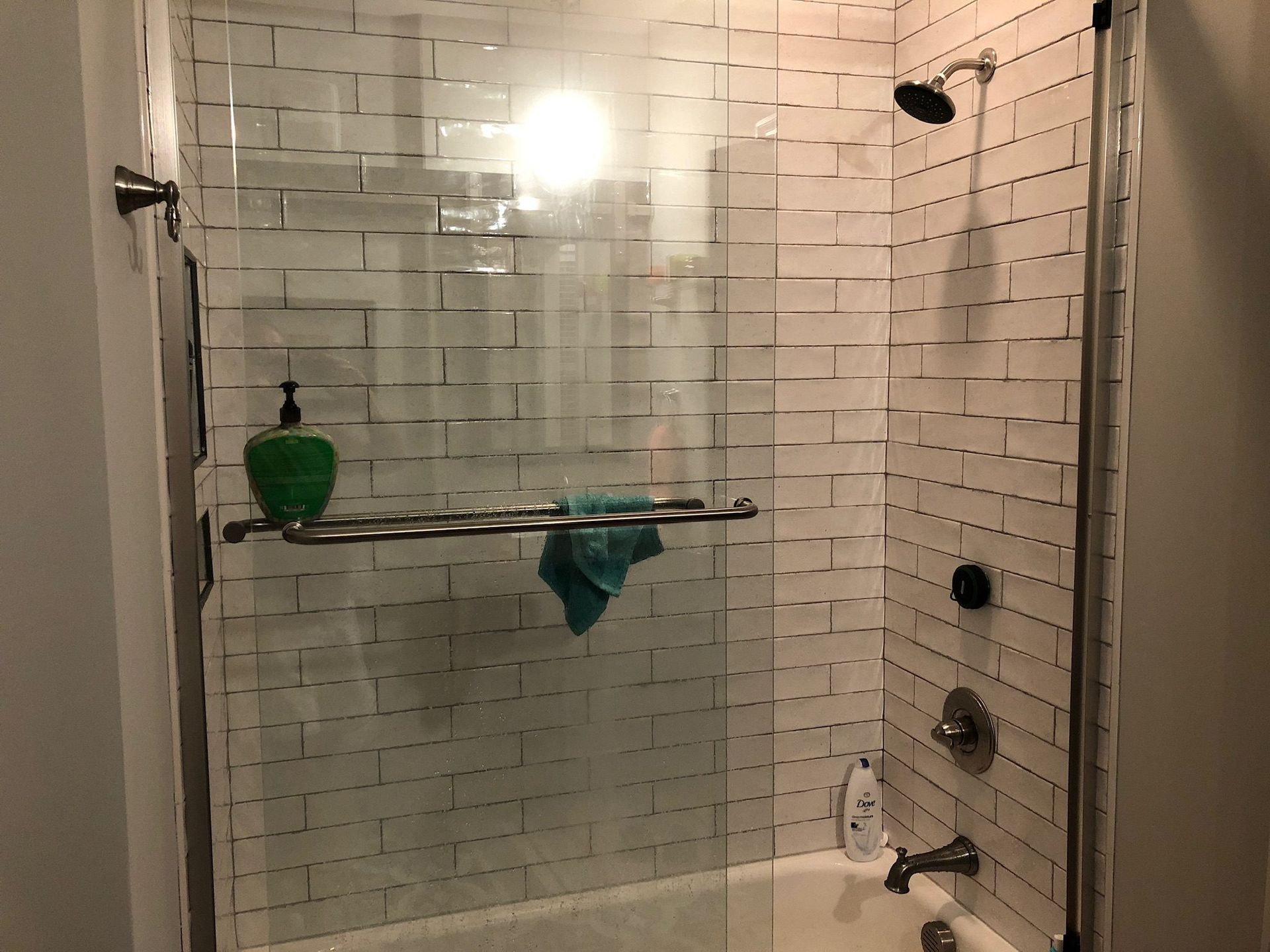 A bathroom with a bathtub and a shower with a glass door