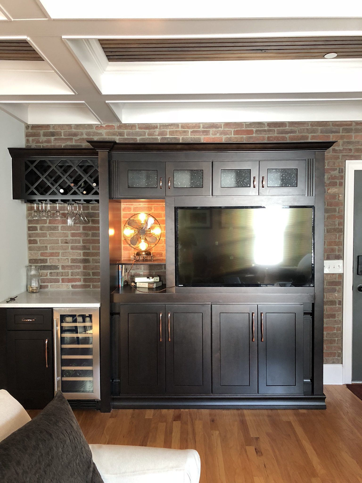 A living room with a tv and a wine cooler