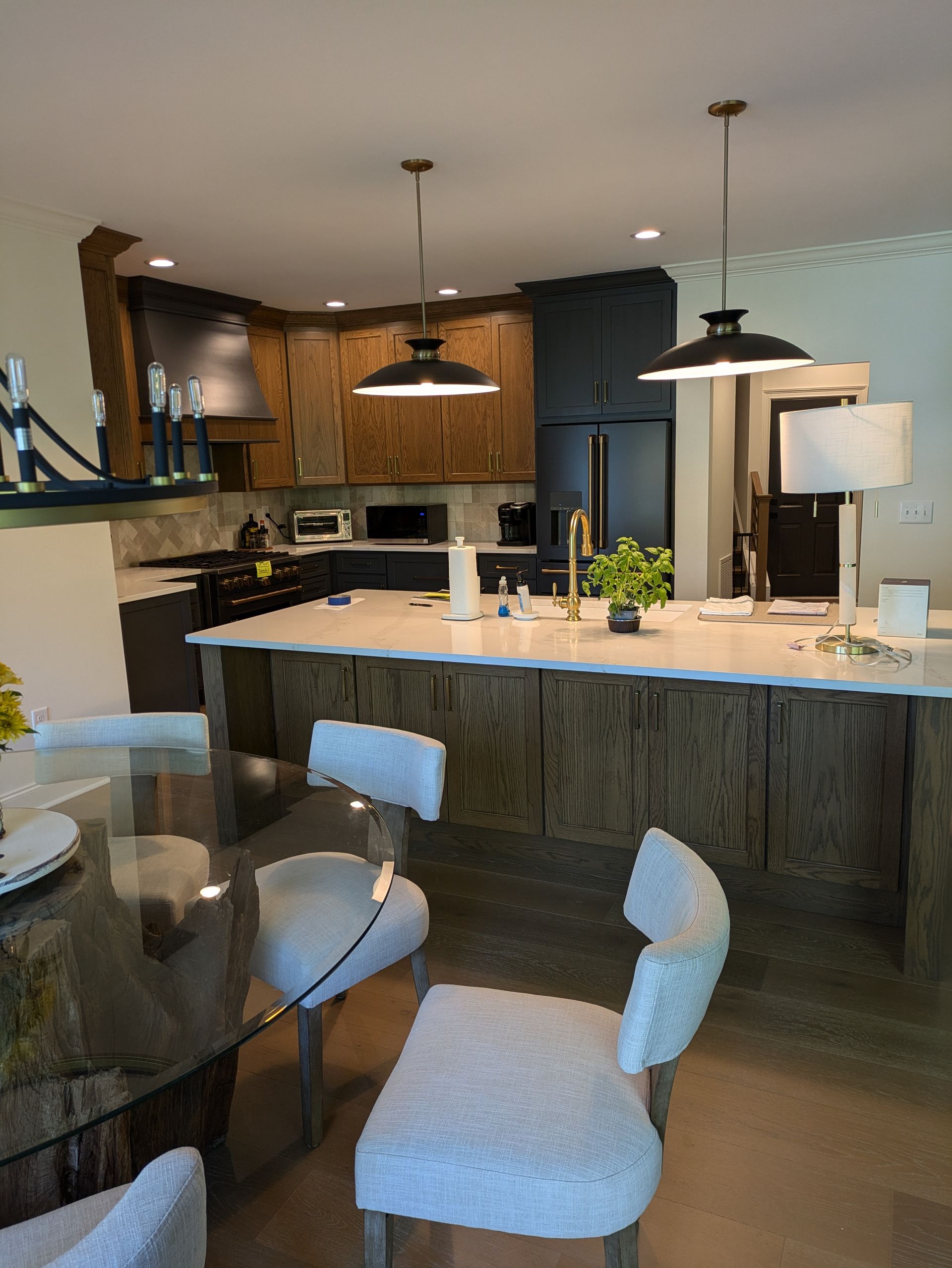 A kitchen with a table and chairs and a large island.