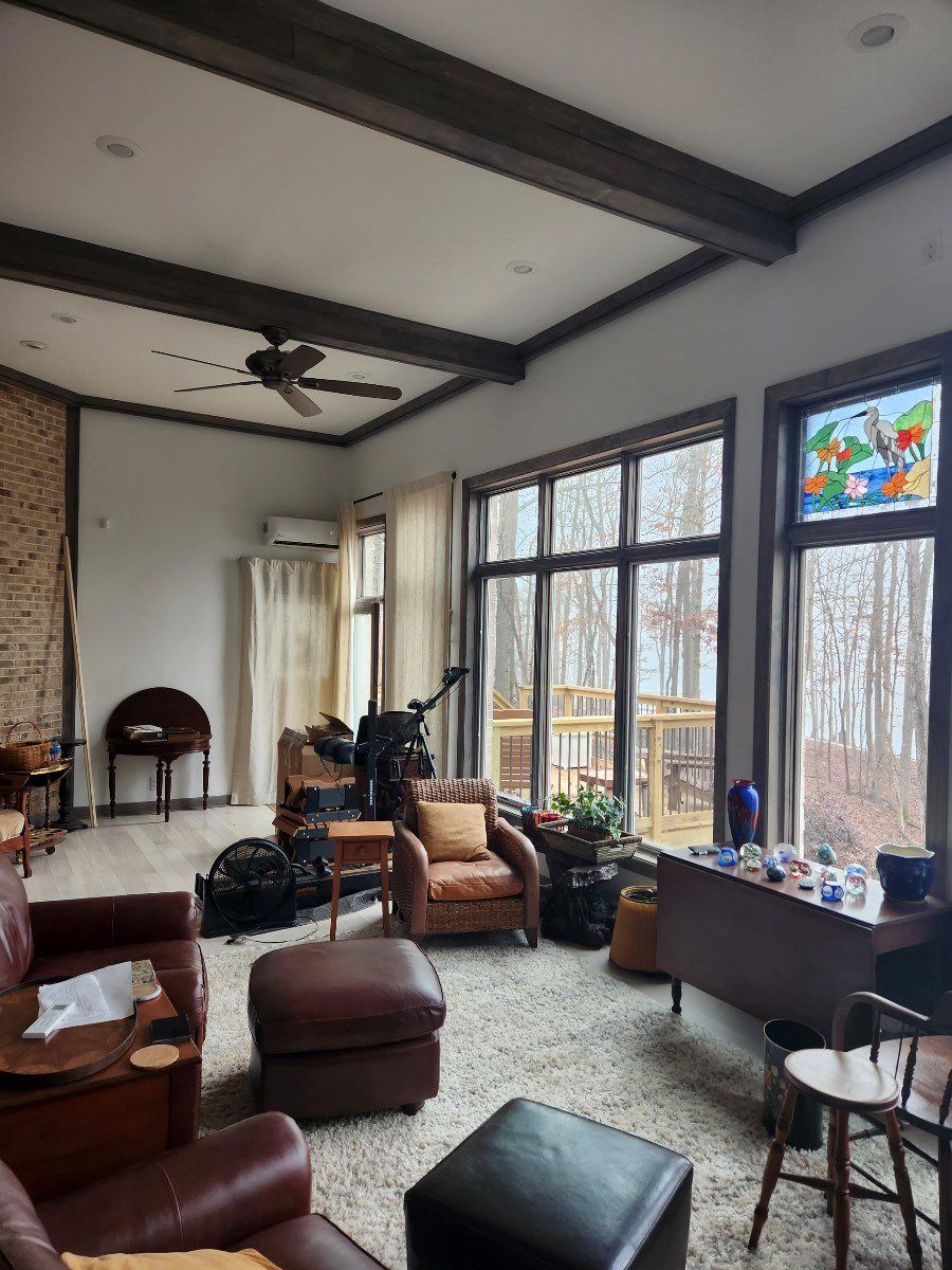 A living room filled with furniture and a ceiling fan.