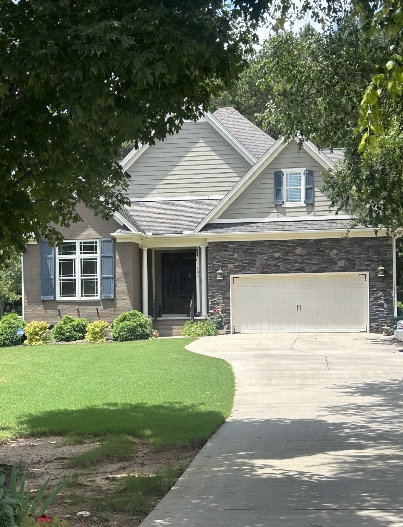 A house with a white garage door and blue shutters