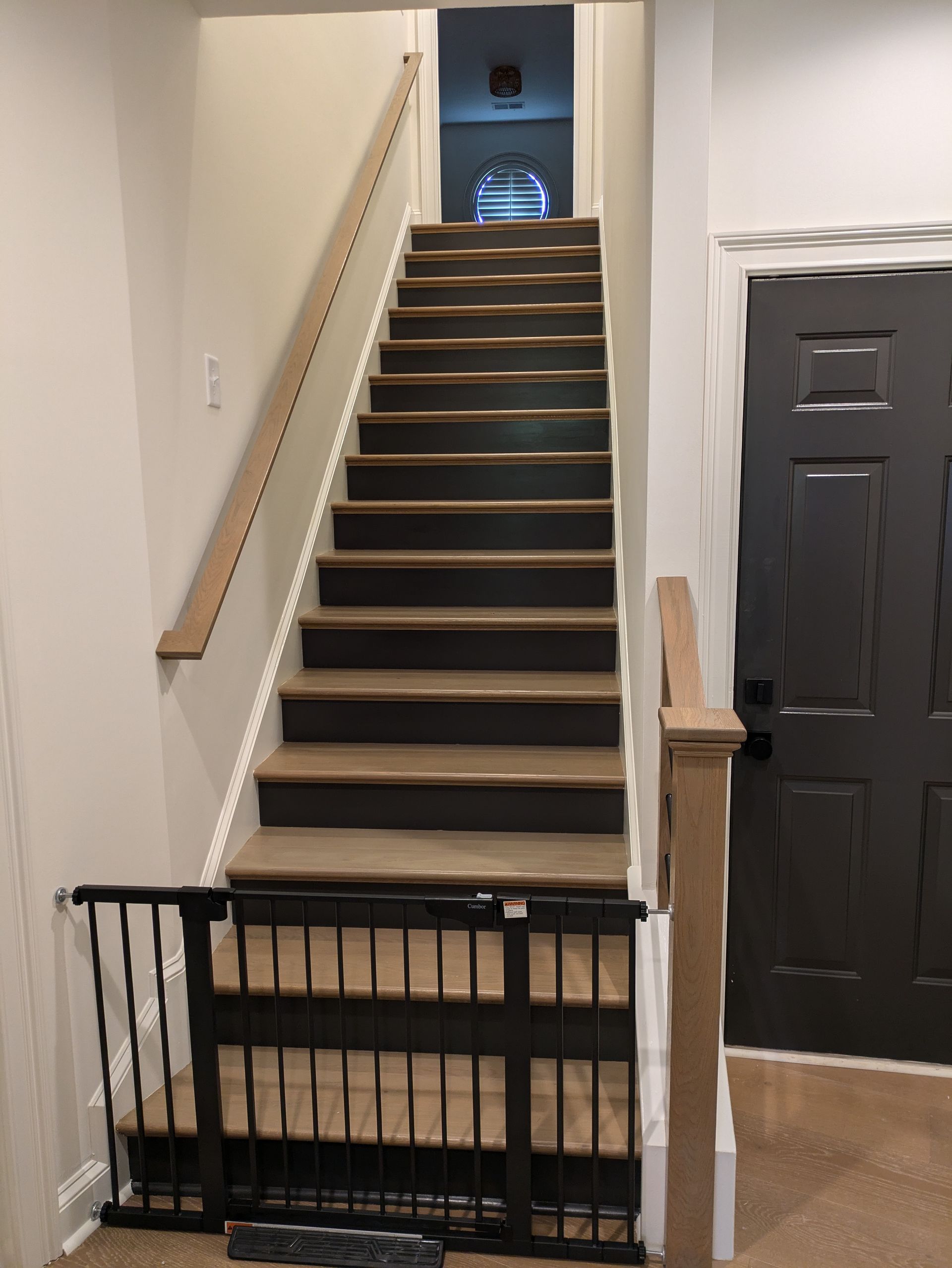 A set of stairs with a black gate between them