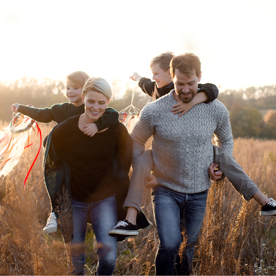 A family is flying a kite in a field.