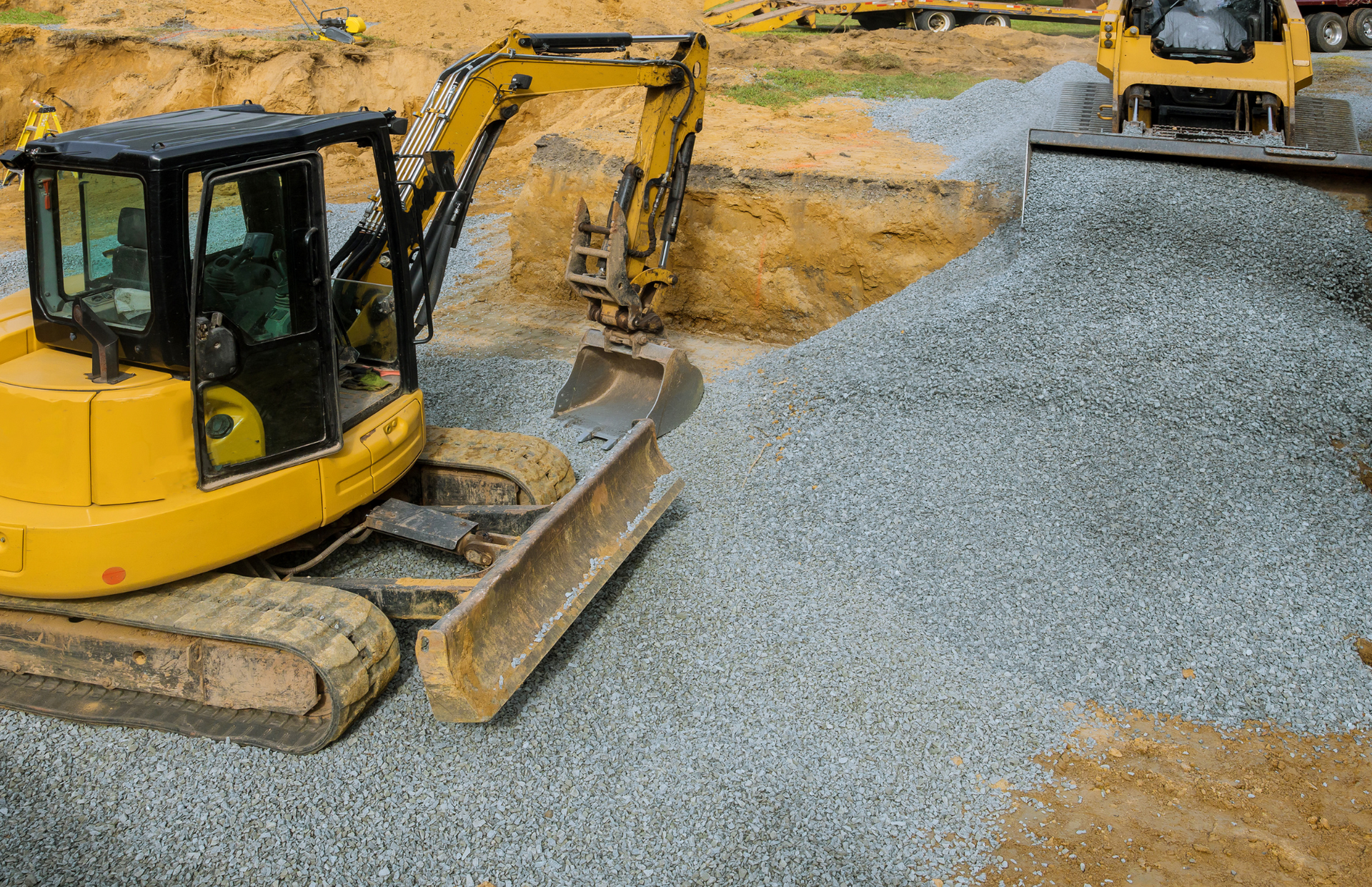 Excavator loading a dump truck with rocks in a quarry; orange machinery.