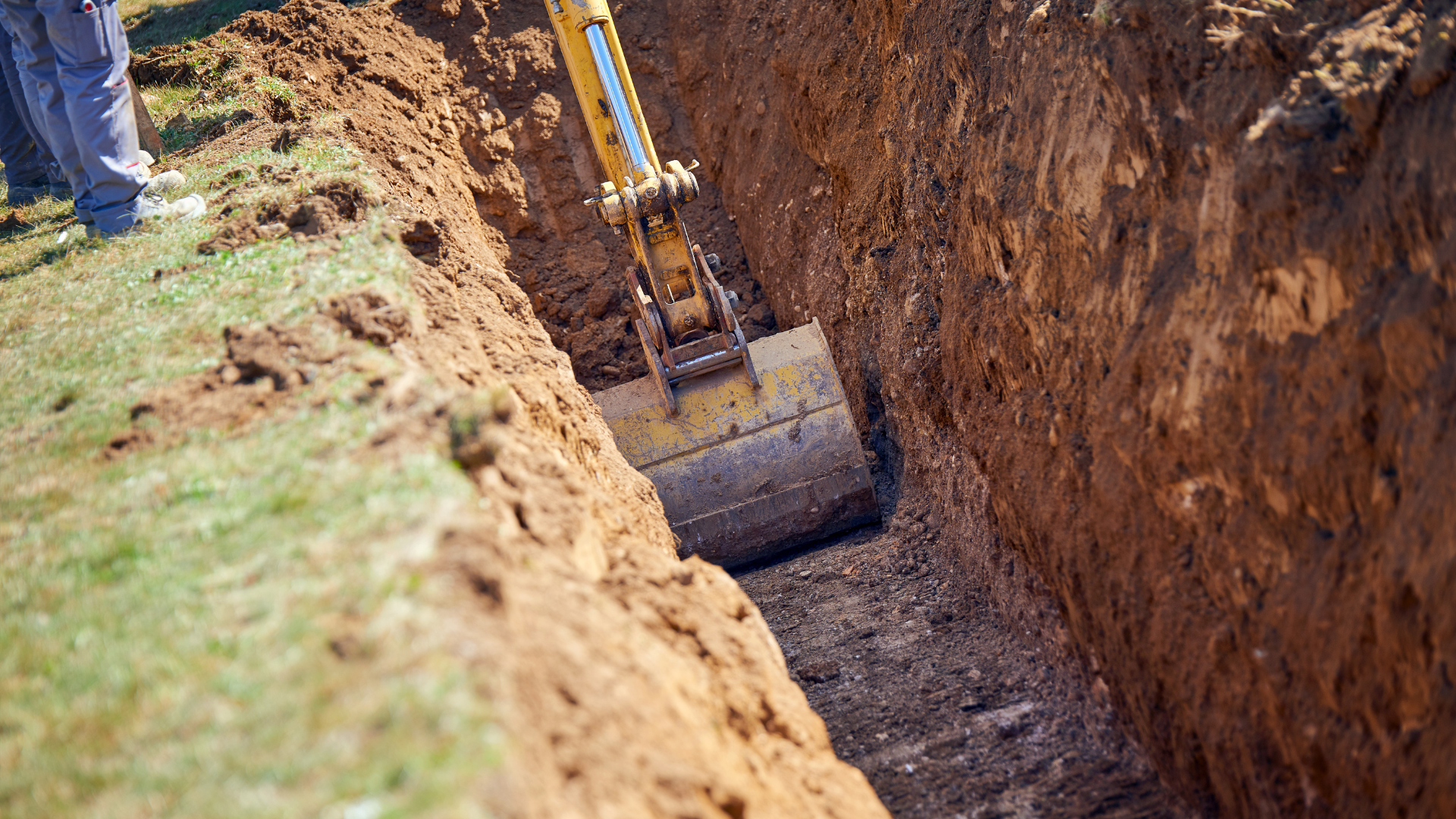 Yellow loader on tan and brown terrain, moving material, overhead view.
