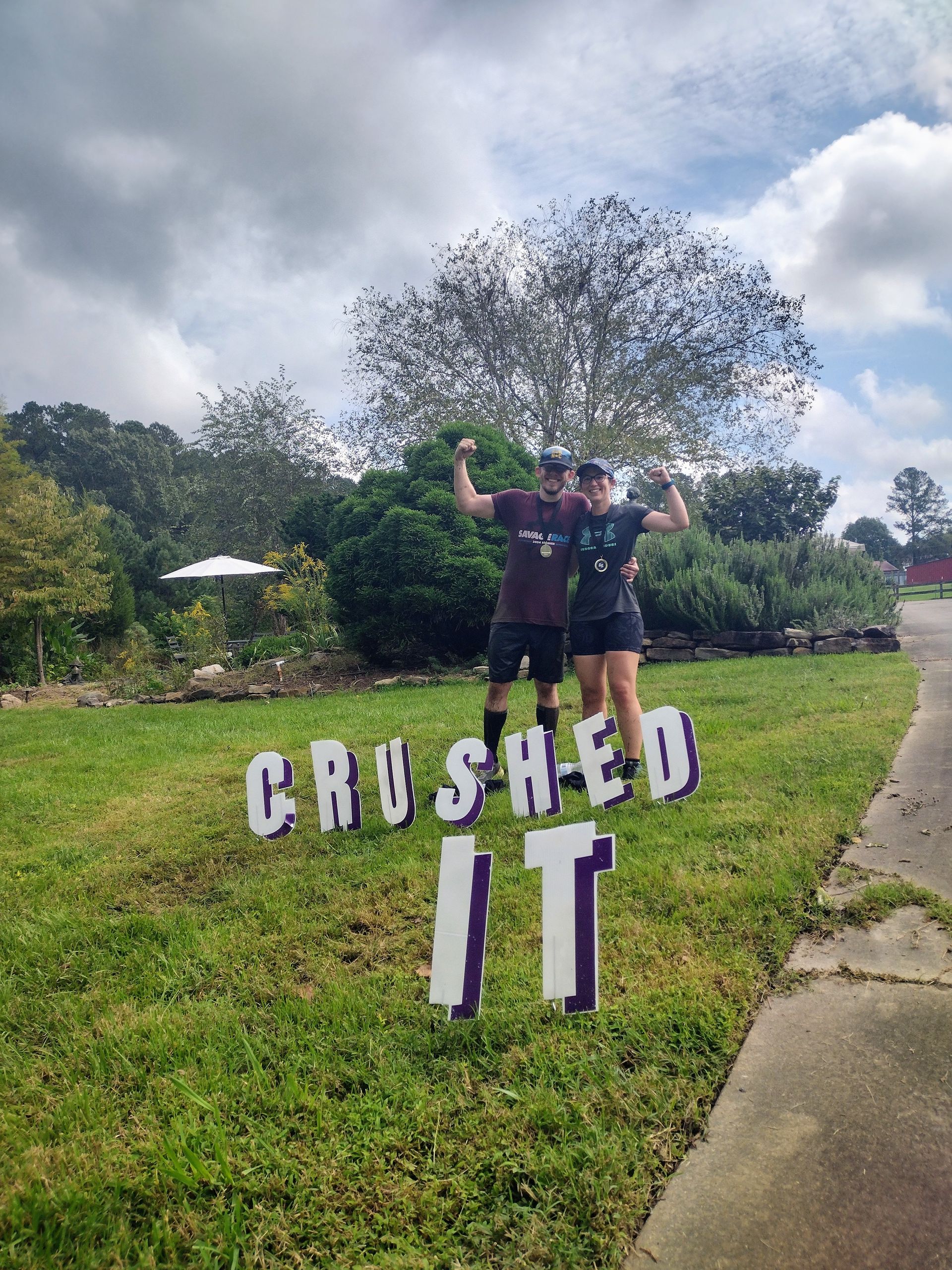 Two people celebrating victory next to a 